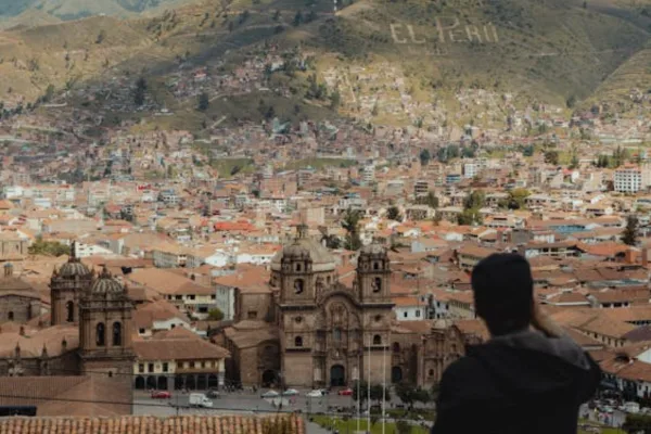 Young man taking a pic at the top of a cusco city tour